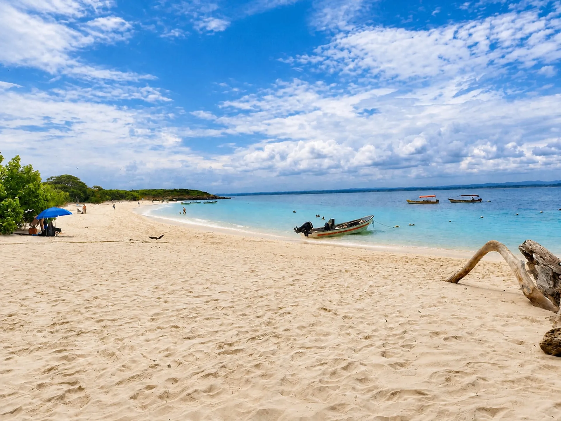 Open fishing boats anchored off a white sand beach.