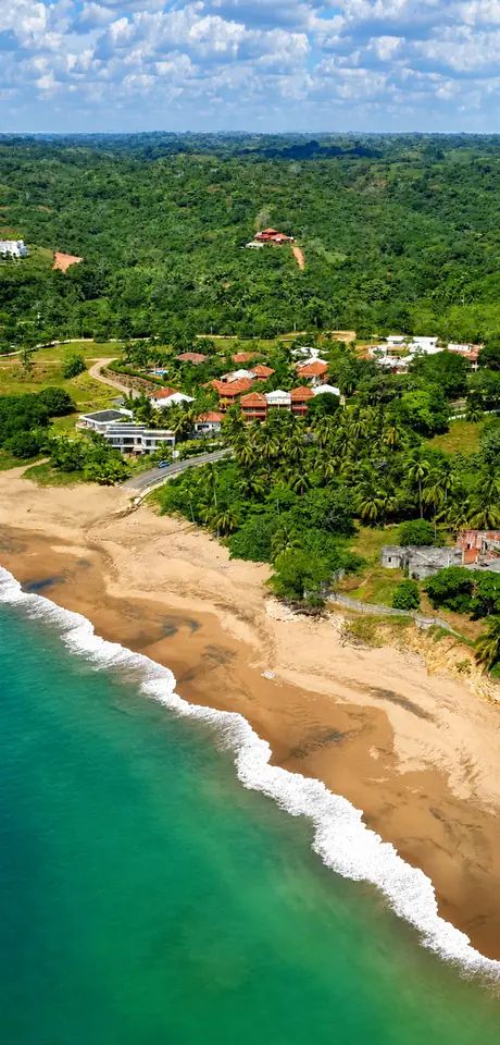 Playa Destiladeros from the air: two kilometres of sand, with the houses set back among the trees