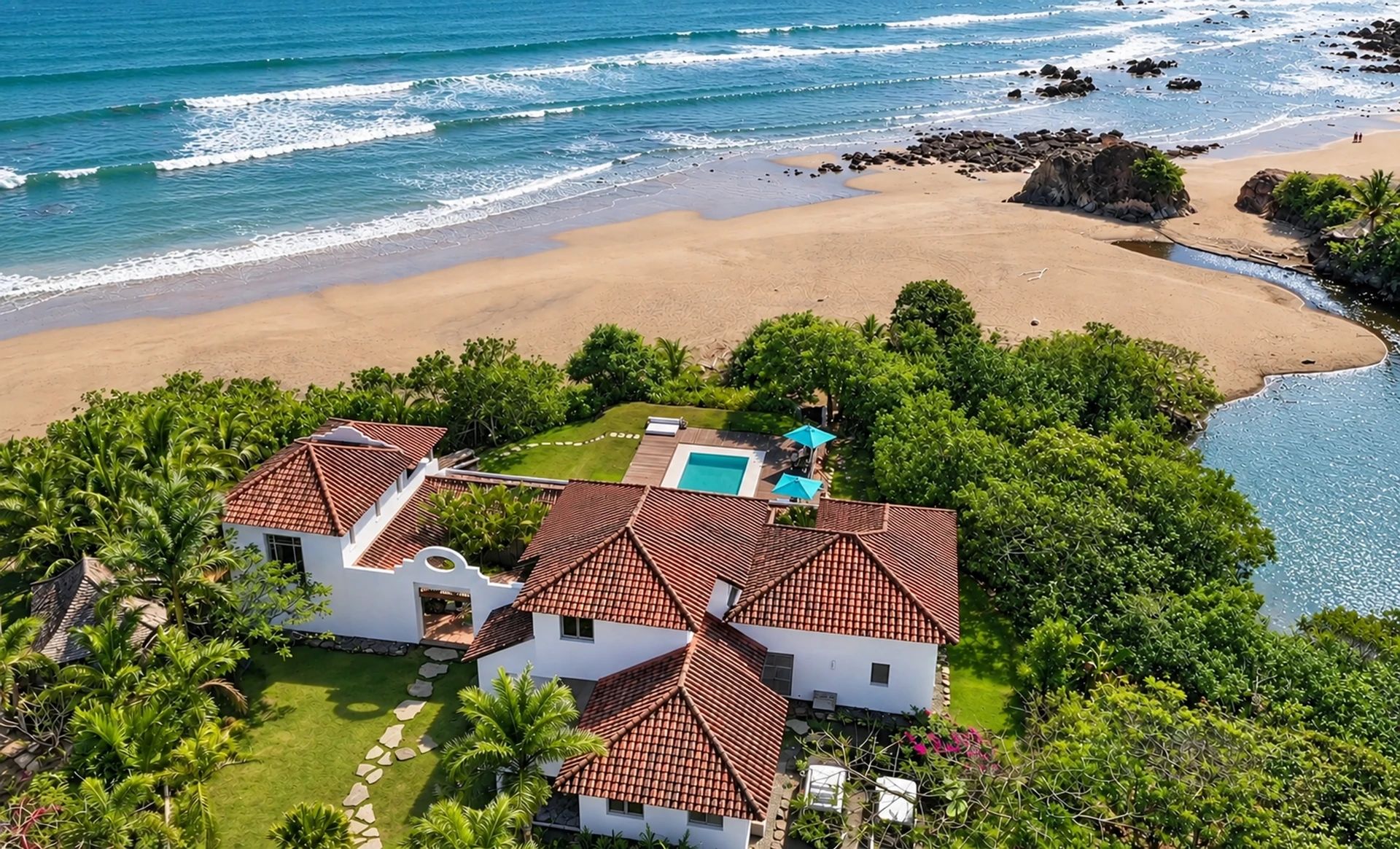 Villa Alborán from the air: the house and the pool above Destiladeros beach, with the rocks and the sea