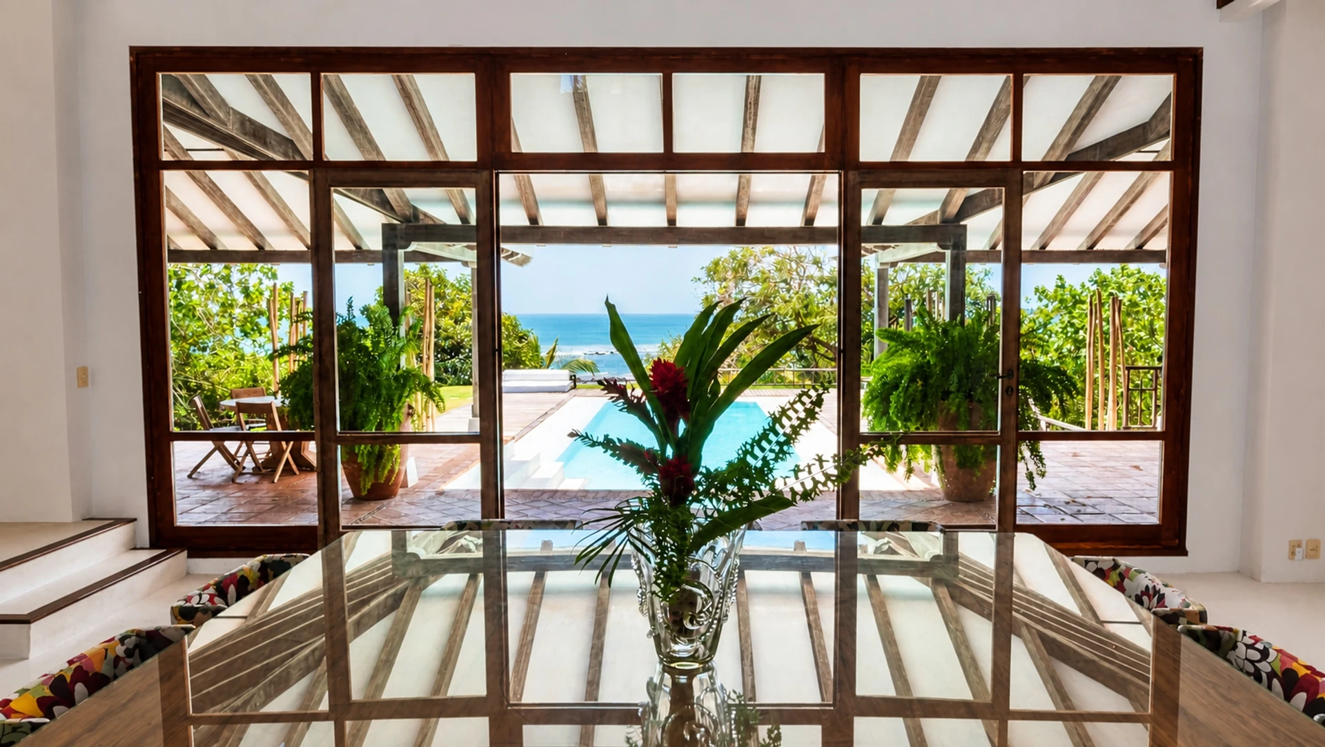 The dining room at Villa Alborán, with the pool and the sea beyond