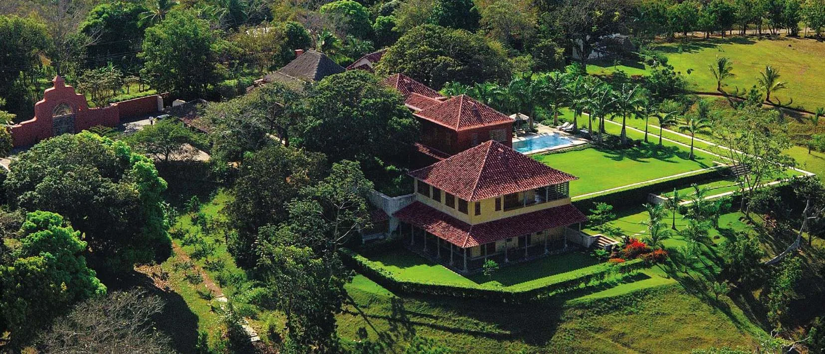 The gardens at Villa Camilla from the air, with the house and the pool